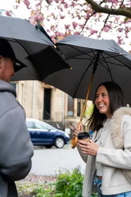 a woman is smiling while holding an umbrella at Hamilton Residence - Private Main Door 1BR in Glasgow