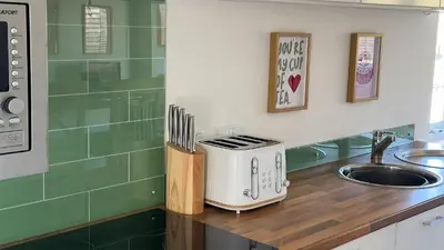a kitchen counter with a toaster and a sink at The Tummel Lodge with Hot Tub in Crieff in Crieff