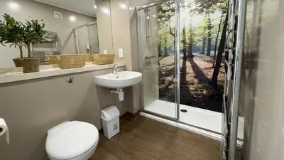 a bathroom with a toilet and a sink and a shower at The Tummel Lodge with Hot Tub in Crieff in Crieff