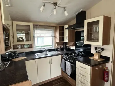 a kitchen with a sink and a stove top oven at New Hampton 36 in Dunoon