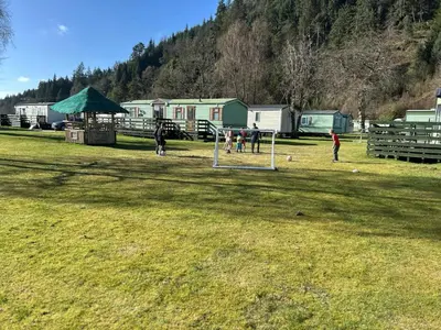 a group of people playing soccer in a field at New Hampton 36 in Dunoon