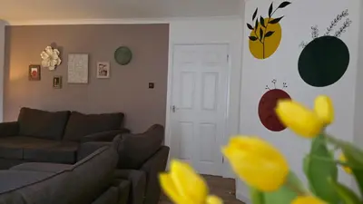 a living room with a couch and a white door at The Ansi9 in Livingston