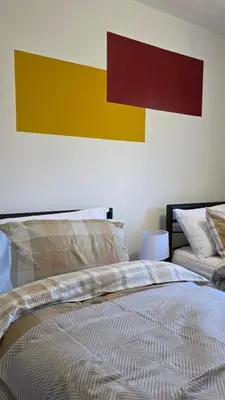a bedroom with a bed and a painting on the wall at The Ansi9 in Livingston
