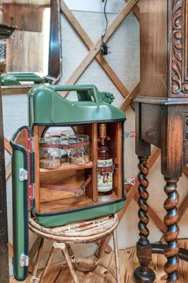 a green toaster sitting on a chair in a room at Magical Quirky Romantic Yurt in Balquhidder in Balquhidder