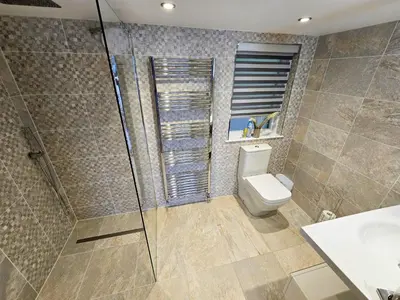a bathroom with a shower and a toilet and a sink at Fyne Edge - A Luxurious Lochside Haven in Minard