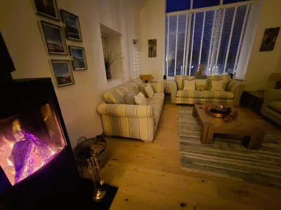 a living room with two couches and a tv at Fyne Edge - A Luxurious Lochside Haven in Minard