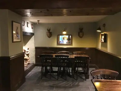 a dining room with a table and chairs at The Clachan Inn in Dalry