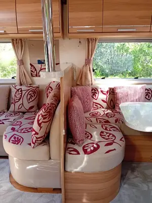 an rv with two beds and a window at Railway cottage caravan in Oban