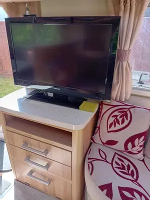 a flat screen tv sitting on top of a table at Railway cottage caravan in Oban