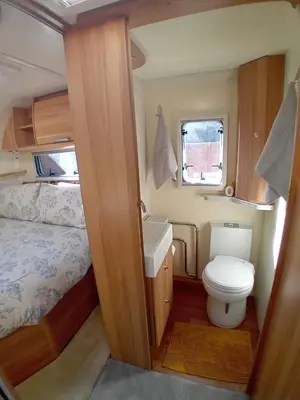 a small bathroom with a toilet and a sink at Railway cottage caravan in Oban