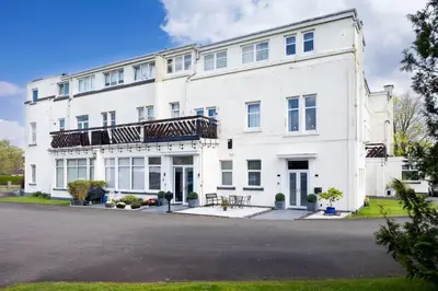 an exterior view of a white building at 2 Bedroom in the Heart of Loch Lomond in Balloch