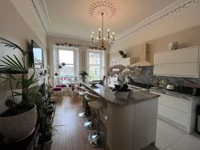 a kitchen with a large island with plants in it at Wonderful 3 Bed West End Flat in Glasgow