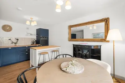 a kitchen with a table and a mirror on the wall at Luxury 2 Bed cottage in Killin in Killin