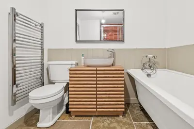a bathroom with a toilet and a tub and a sink at Luxury 2 Bed cottage in Killin in Killin