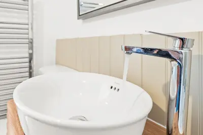 a bathroom with a sink and a faucet at Luxury 2 Bed cottage in Killin in Killin
