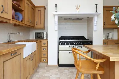 a kitchen with a stove and a wooden counter at Greenknowes Entire Private Estate in Kelty