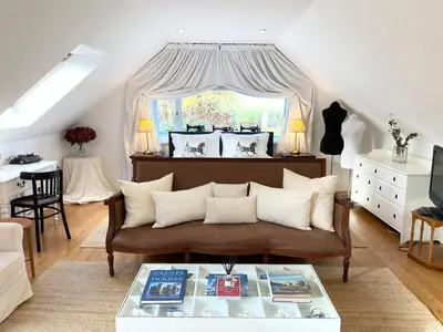 a living room with a couch and a table at Converted Historical Stone Coach House in Glasgow
