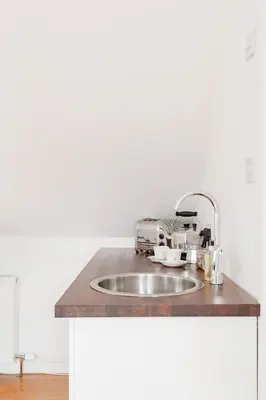 a kitchen sink with a toaster on top of it at Converted Historical Stone Coach House in Glasgow