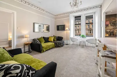 a living room with a couch and a table at Stunning 1Bedroom Central Apartment in Oban