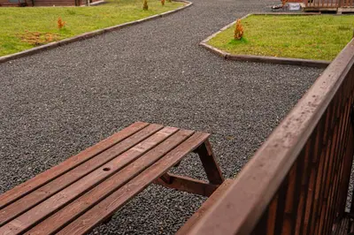 a wooden bench sitting on the side of a road at Lodge 1 in Stirling