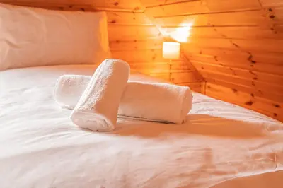 a bed with two towels on top of it at Lodge 1 in Stirling