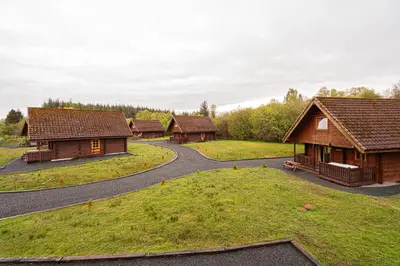 a group of wooden cabins with a winding road at Lodge 3 in Stirling