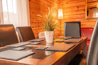 a long wooden table with a potted plant on it at Lodge 3 in Stirling