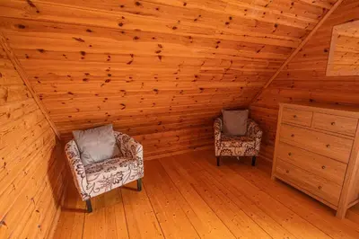 two chairs in a room with wooden walls and wooden floors at Lodge 3 in Stirling