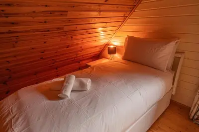 a bedroom with a bed with a light on it at Lodge 4 in Stirling