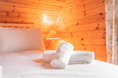 a bedroom with a bed with towels on it at Lodge 5 in Stirling