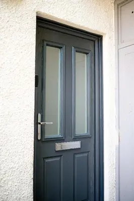 a black door with a window on a building at Modern 1BR Apartment - Close to ferry terminal with free parking in Oban