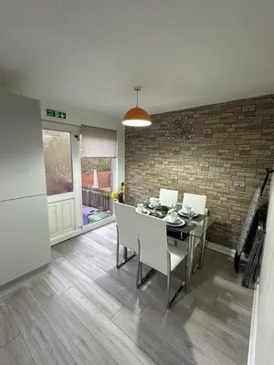 a kitchen and dining room with a table and chairs at My Glasgow House Robroyston in Hogganfield