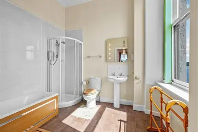 a bathroom with a shower toilet and a sink at Rosemount in Campbeltown
