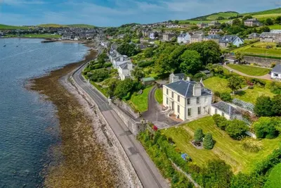 an aerial view of a house next to the water at Rosemount in Campbeltown