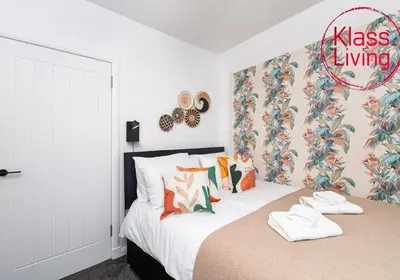 a bedroom with a bed with white shoes on it at Sanderson Upper by Klass Living Uddingston in Uddingston