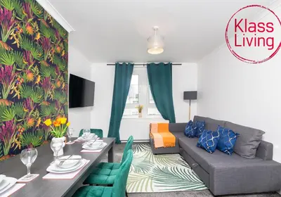 a living room with a table and a couch at Sanderson Upper by Klass Living Uddingston in Uddingston