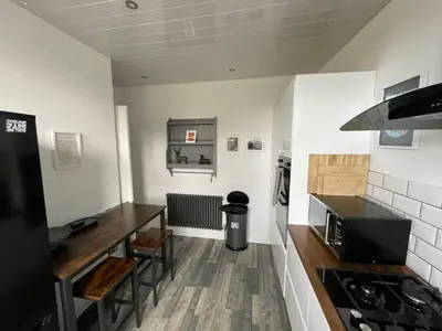 a kitchen with a stove and a counter top at Isle of Bute Blissful Retreat- Stunning 3 Bed Flat in Rothesay