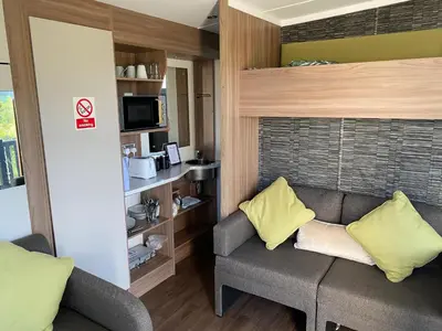 a living room with a gray couch and yellow pillows at The View in Ballantrae