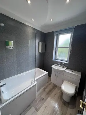 a bathroom with a tub and a toilet and a sink at Helensburgh Central Apartment - Macaulay Letting in Helensburgh