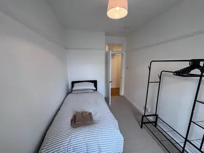 a small bedroom with a bed in a room at Helensburgh Central Apartment - Macaulay Letting in Helensburgh