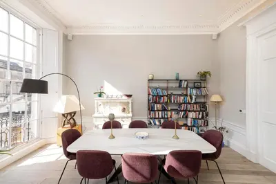 a dining room with a table and chairs at Melville Street Townhouse in Edinburgh
