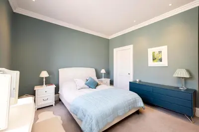 a bedroom with a bed and two night stands at Melville Street Townhouse in Edinburgh