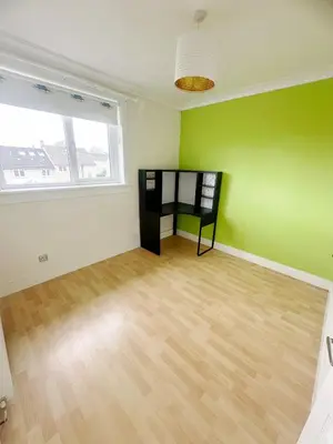 a room with green and white walls and a wooden floor at Galaxy Glasgow 67 in Cardonald
