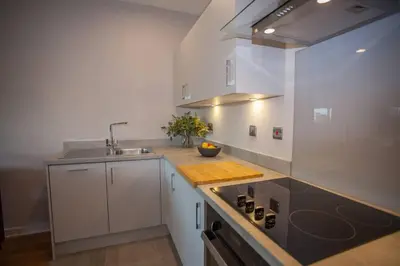 a kitchen with a sink and a counter top at Stylish 2-Bed Apartment Near Glasgow Green in Glasgow
