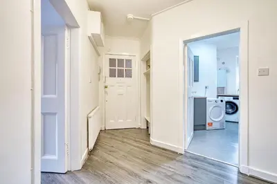 an empty hallway with a door open to a laundry room at 2BR Shawlands Free Parking Great Location in Glasgow