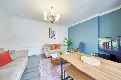 a living room with a table and a couch at 2BR Shawlands Free Parking Great Location in Glasgow