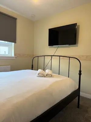a bedroom with a bed with two towels at 2-Bed City Apartment by Glasgow Green in Glasgow