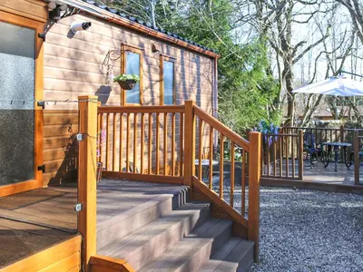 a wooden staircase leading to a tiny house at Burnside Lodge in Auchterarder