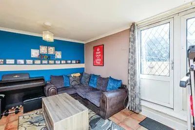 a living room with a couch and a piano at Guild Close in Moffat
