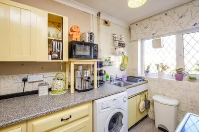 a kitchen with a sink and a washing machine at Guild Close in Moffat